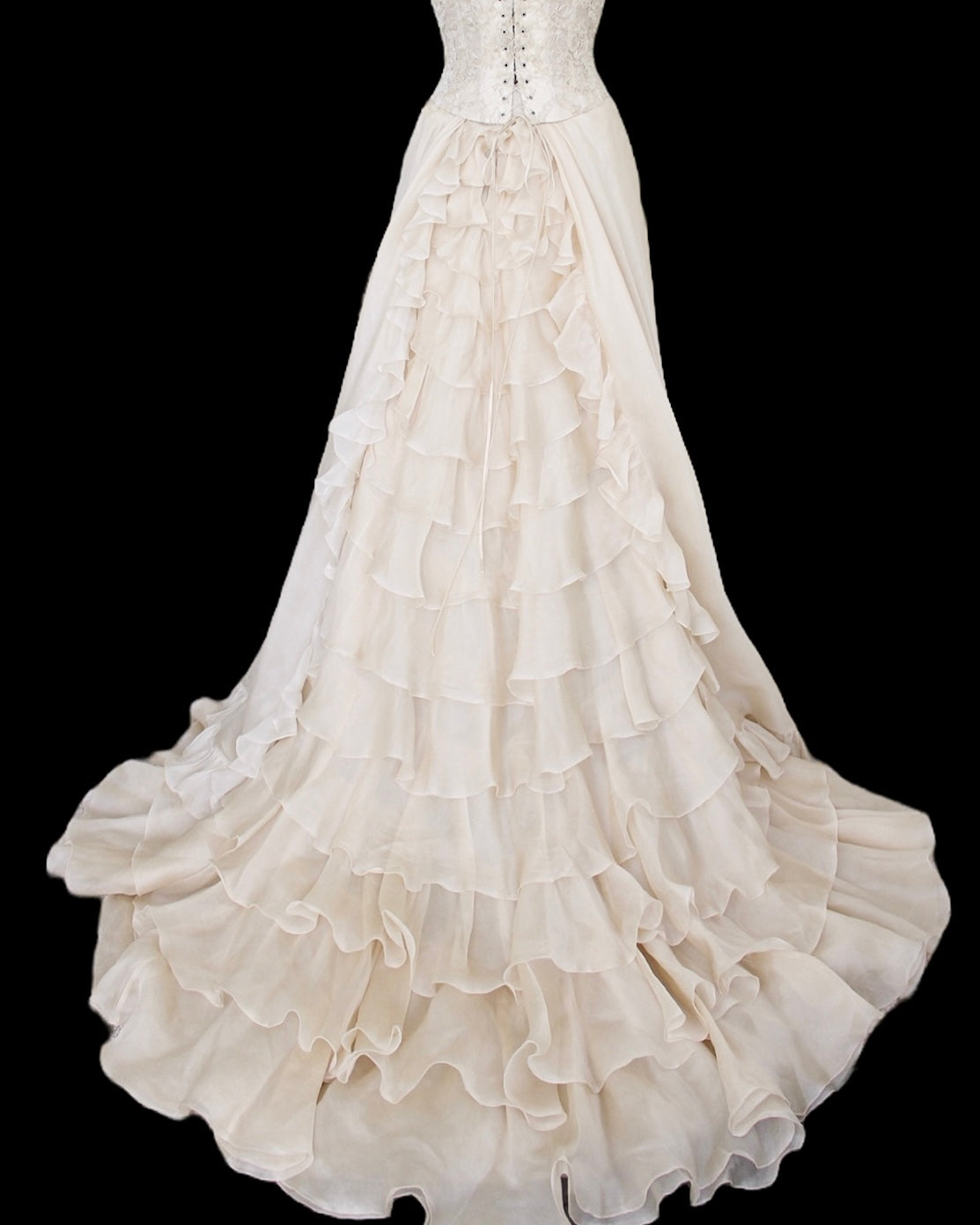 White wedding dress with ruffled skirt on a black background