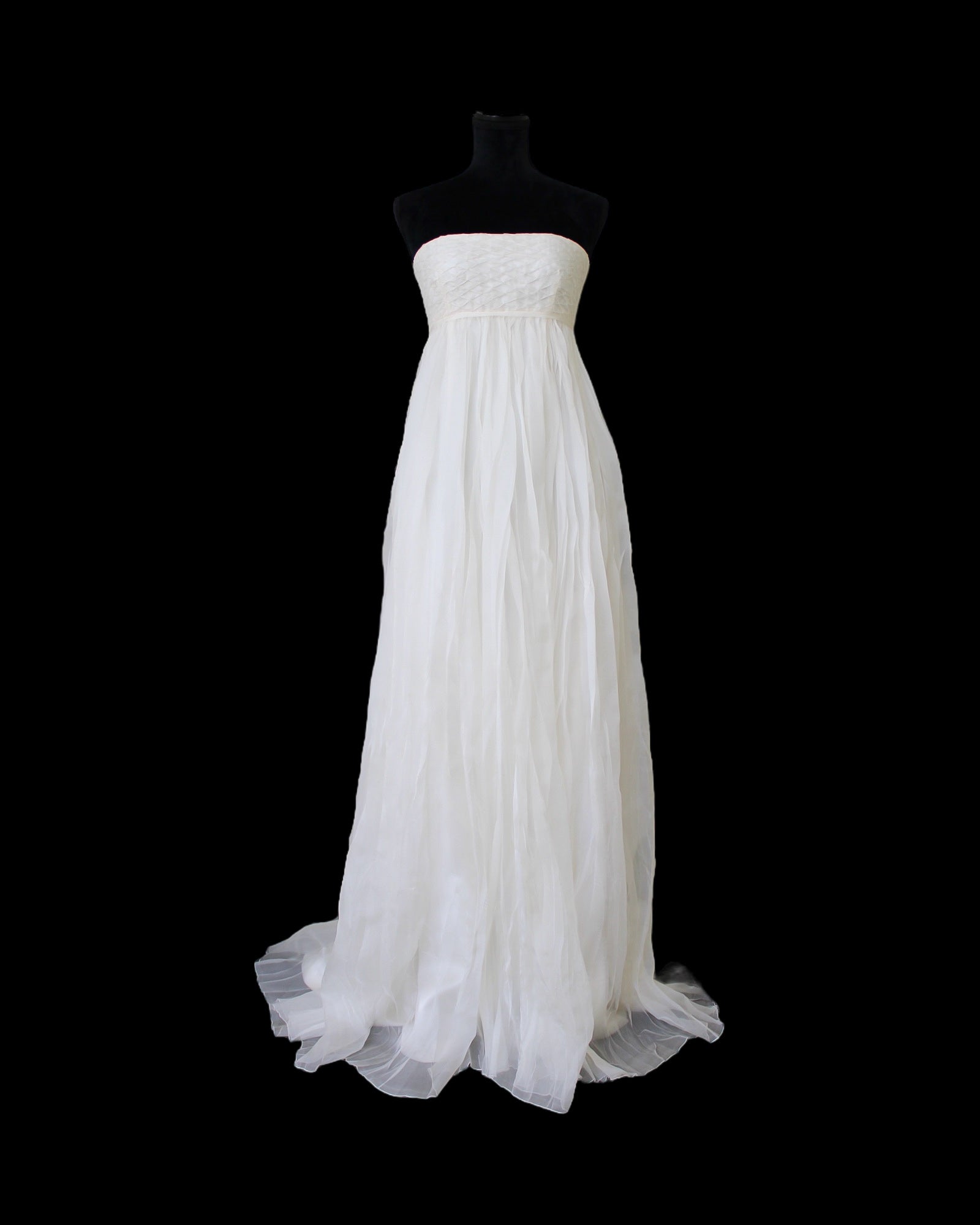 White strapless gown on a black mannequin against a white background